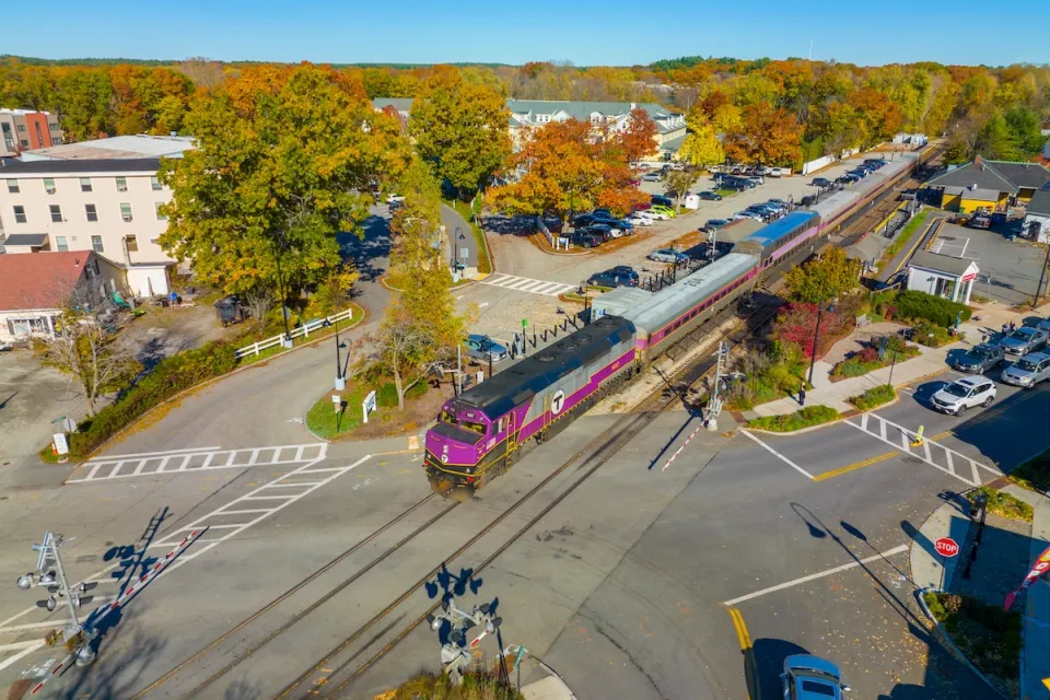Aerial view of purple MBTA train at West Concord station in Concord, Massachusetts.